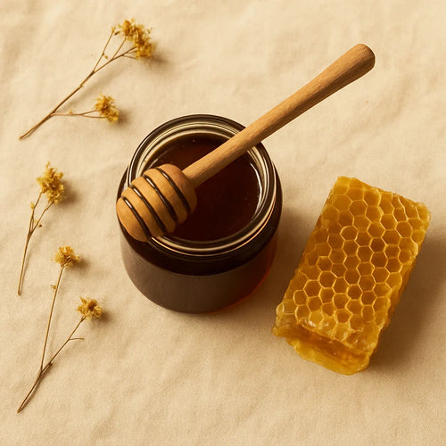 Raw wild forest honey in a glass jar with honeycomb showing unprocessed natural honey