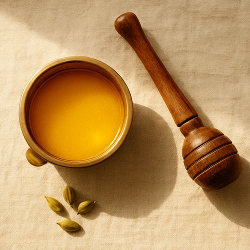 A2 bilona ghee in a brass pot with traditional wooden churner showing the traditional ghee-making process