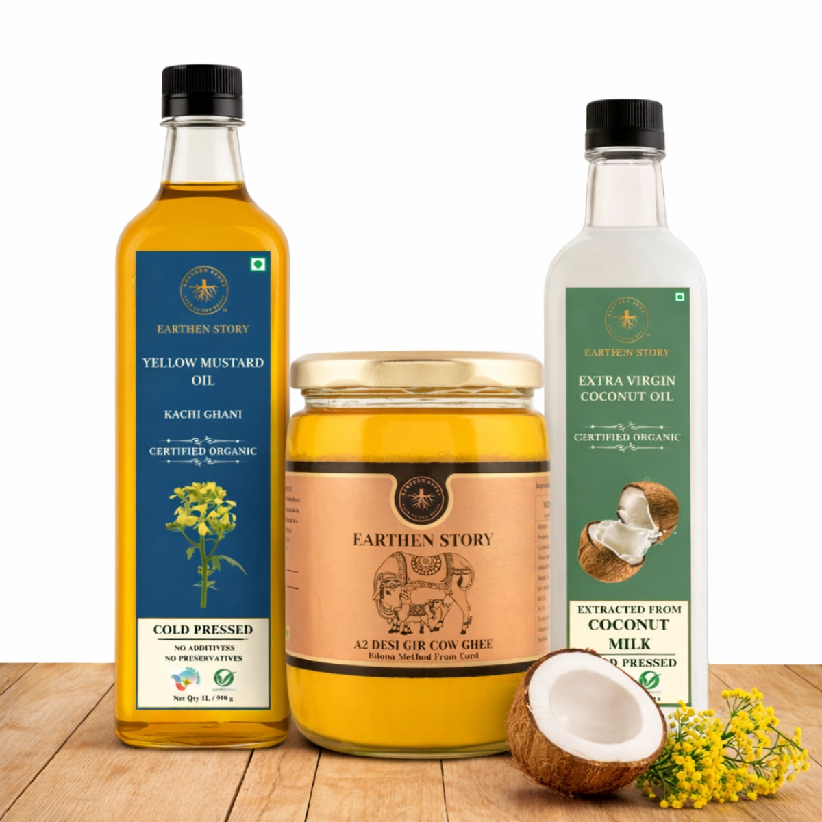 Everyday Cooking Base Bundle with a2 gir cow ghee, yellow mustard oil, and extra virgin coconut oil on a plain white background on a wooden desk.