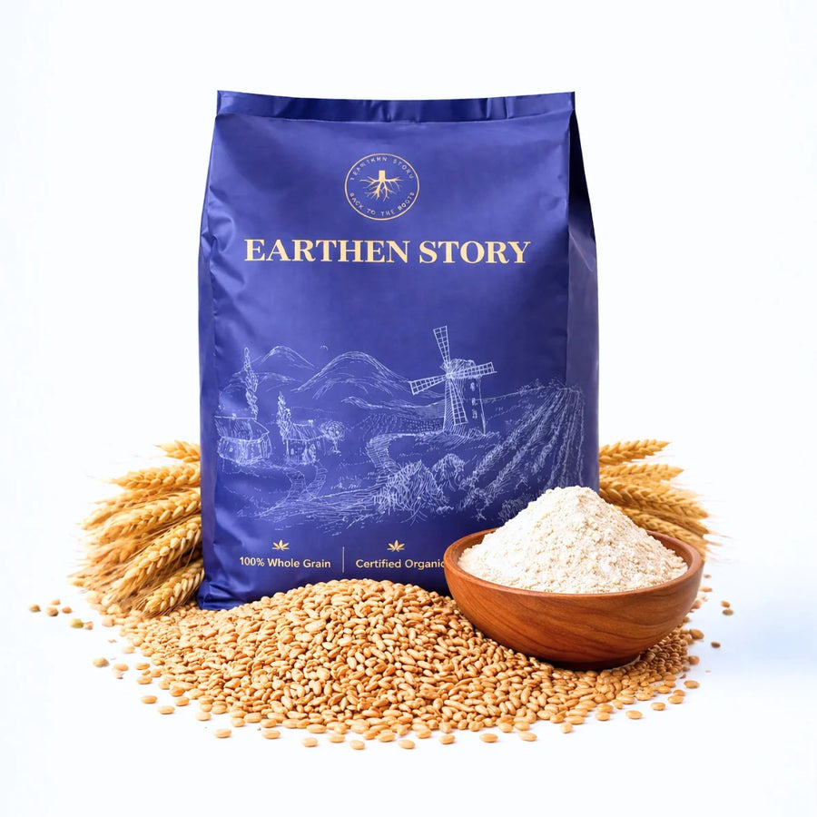 Earthen Story organic whole wheat atta with raw wheat grains, wheat ears, and flour in wooden bowl