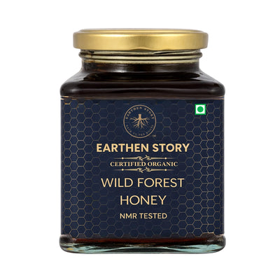 Earthen Story Certified Organic Wild Forest Honey in glass jar with gold lid and hexagonal pattern label